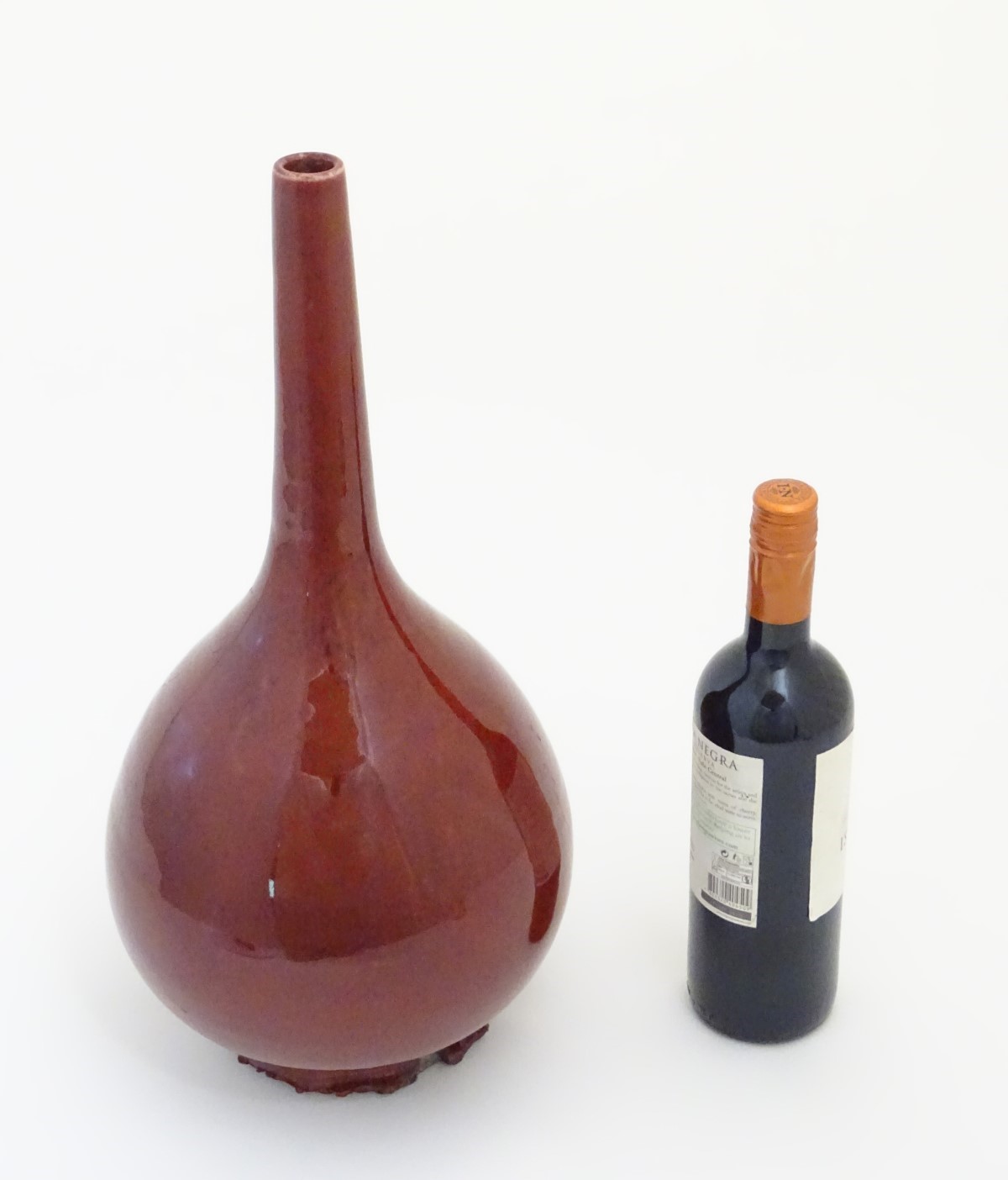 A Chinese pear-shaped vase with a slender, elongated neck with a sang de boeuf glaze. Approx. - Image 4 of 5