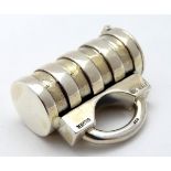 An unusual silver vesta case of cylindrical form with loop handle.