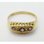 An early 20thC 18ct gold ring set with garnets and rubies.