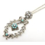 A silver necklace and pendant set with turquoise,