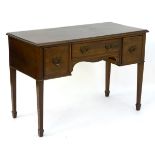 A mid 20thC mahogany desk with a moulded rectangular top above single central drawer and two deep