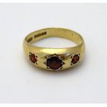 A 9ct gold ring set with garnets.