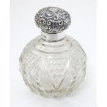 A cut glass scent / perfume bottle with silver top hallmarked Birmingham 1904 4 1/2" high overall