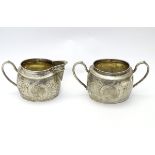 A twin handled sucrier and milk jug with engraved decoration. Marked under Sterling Silver.