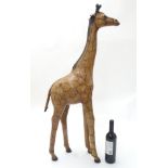 A Liberty style sculpted figure of a Giraffe, leather finish with black painted detail,
