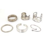 6 assorted silver and white metal bracelets many of bangle form.
