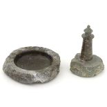 A Cornish souvenir carved piece of serpentine formed as a lighthouse on a rocky base,