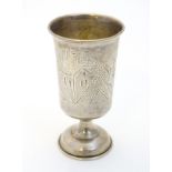 A Russian silver vodka cup with engraved decoration 2 1/2" high CONDITION: Please