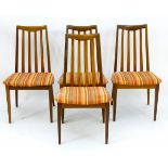 Vintage Retro: A set of four teak G-Plan dining chairs with slatted back rests and standing on