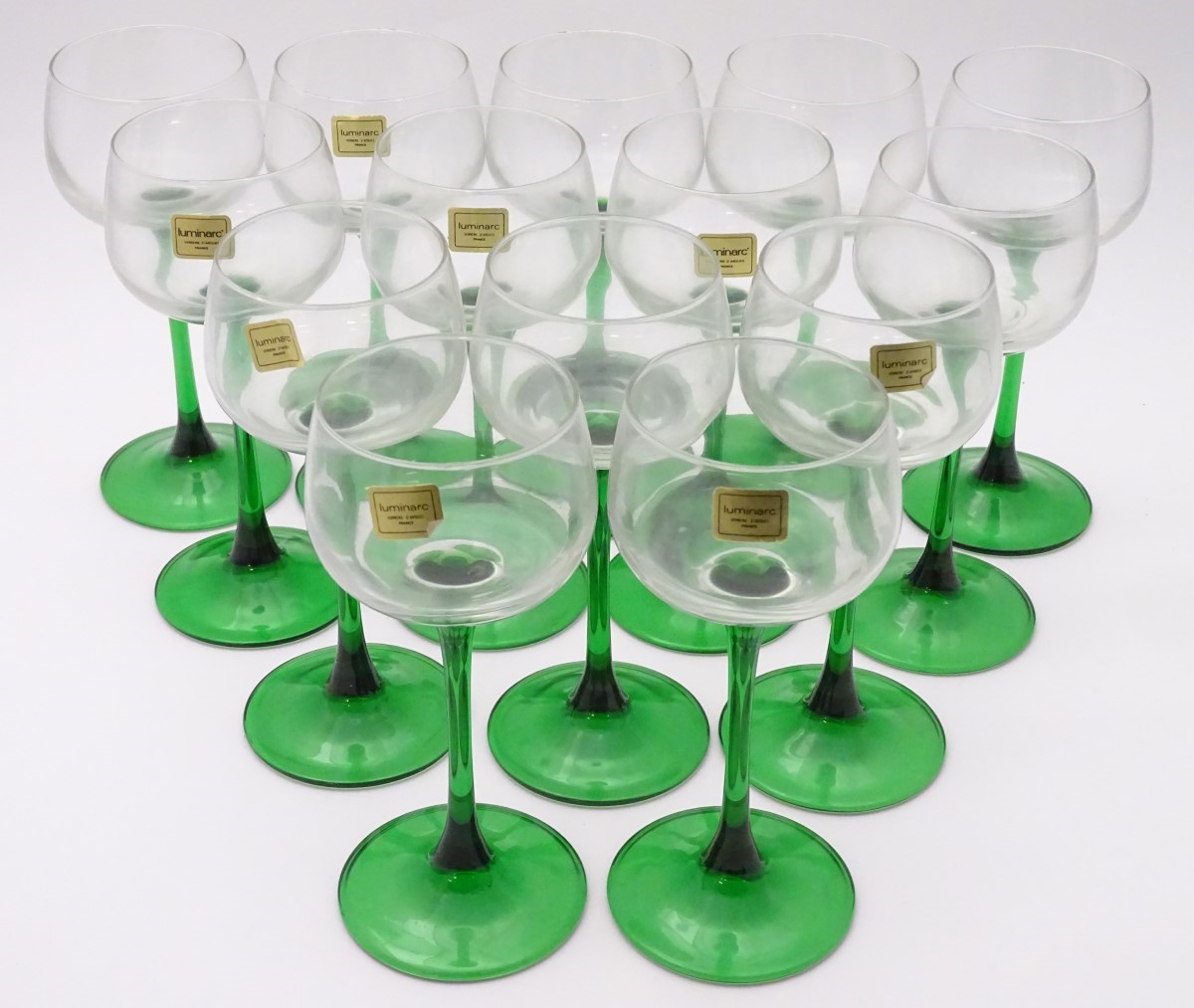 A collection of thirteen mid 20thC retro wine glasses by Luminarc, each with green stem,