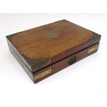 A 19thC mahogany and brass bound campaign style hinged box with with an inlaid brass cartouche to