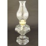 A 20thC clear glass oil lamp of octagonal form.