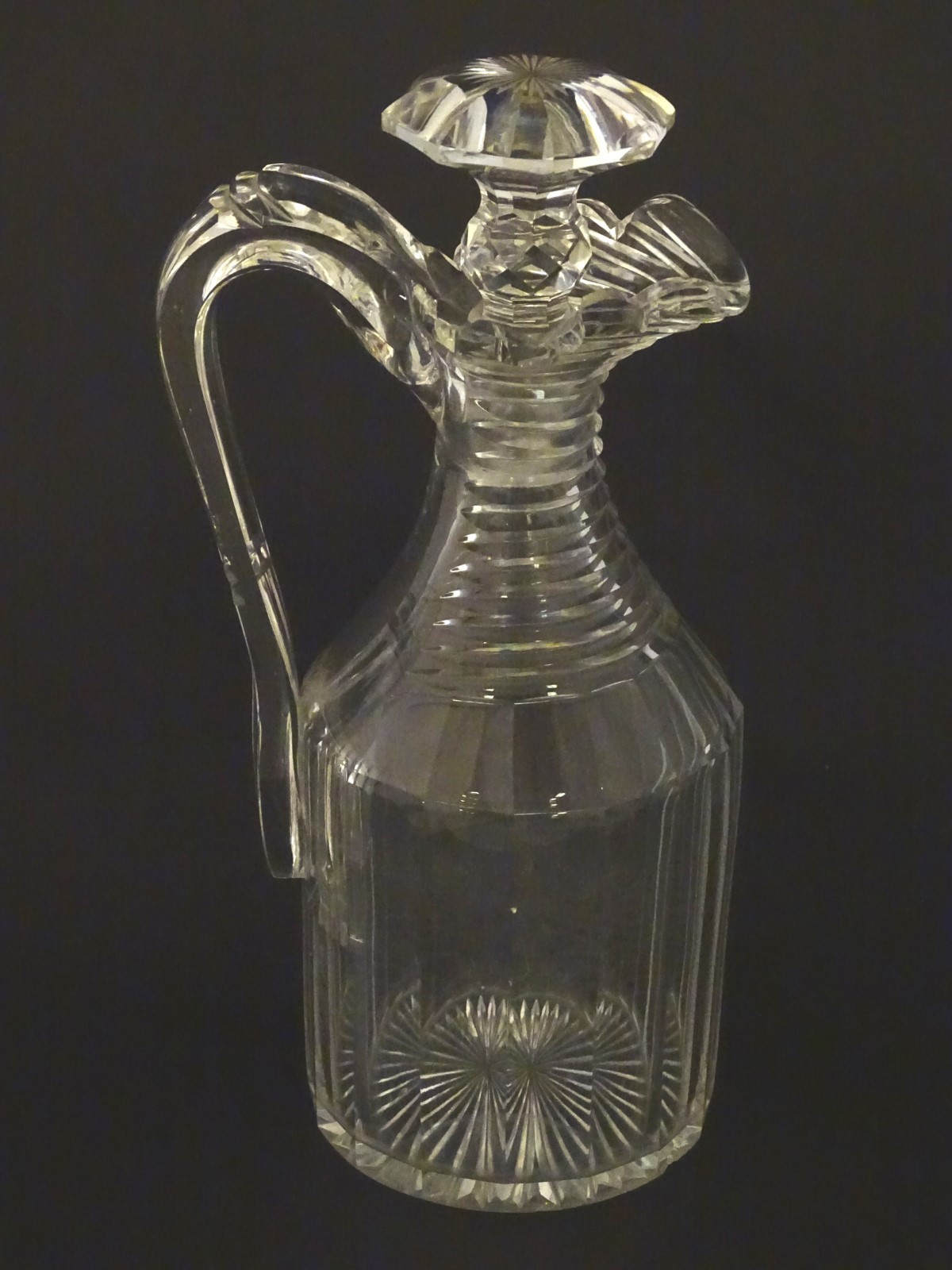 A 19thC Irish cut glass decanter and stopper, having a panelled body with ribbed neck,