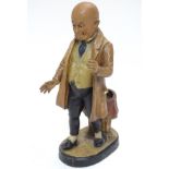 A Victorian terracotta figure of a bald man in a cravat and waistcoat,