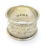 A silver napkin ring with engraved decoration hallmarked Birmingham 1900 maker William Oliver.