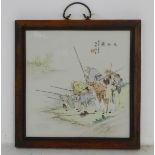 A 20thC Chinese wooden wall hanging with a porcelain panel depicting elders fishing on the bank of