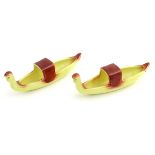 A pair of Peebles of Scotland Miniature Pottery long boats, with yellows grounds and red highlights.