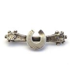 A Victorian silver brooch with horseshoe decoration.