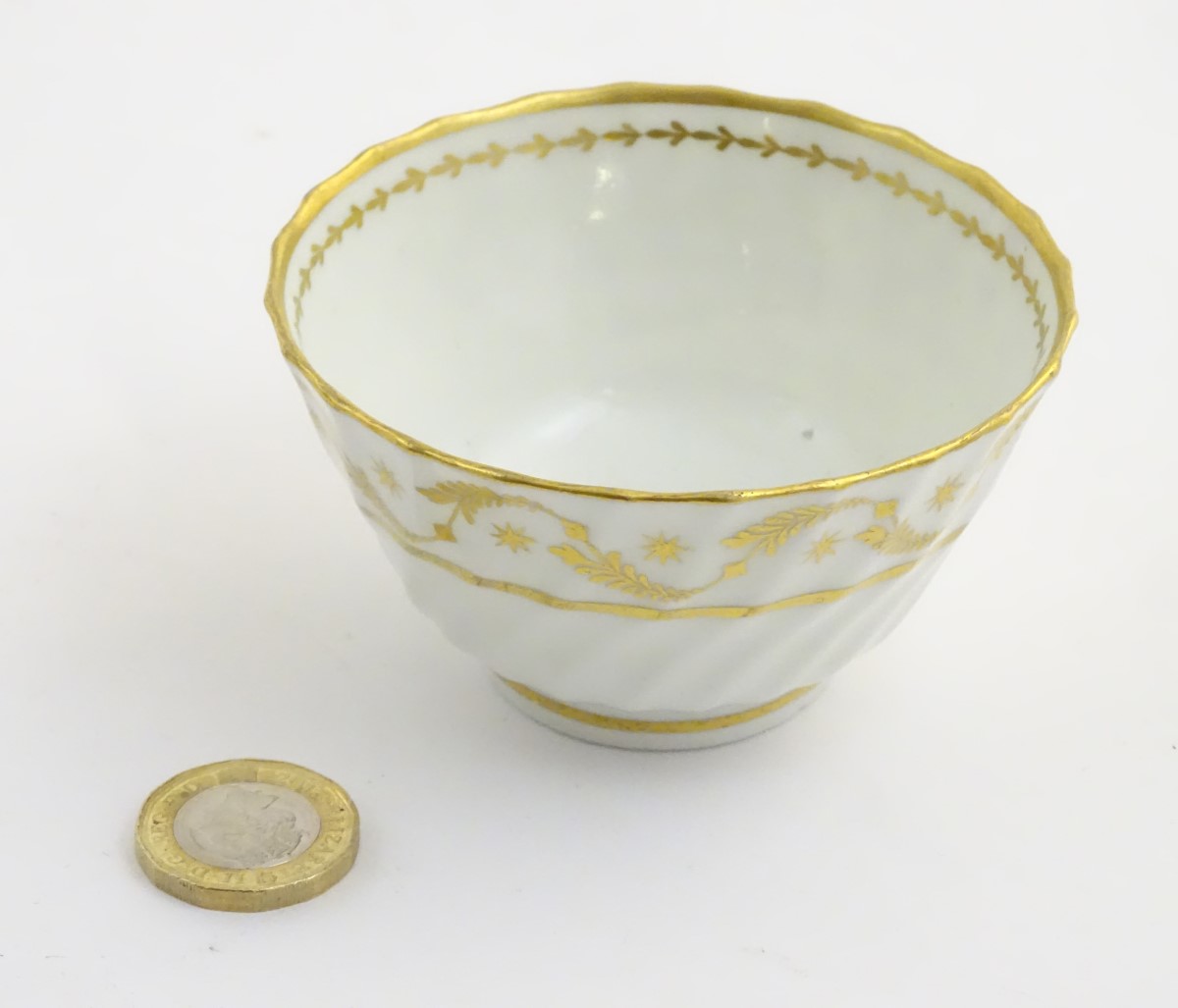 A 19thC white porcelain tea bowl with ribbed sides and gilt decoration of stylised foliage and - Image 6 of 7