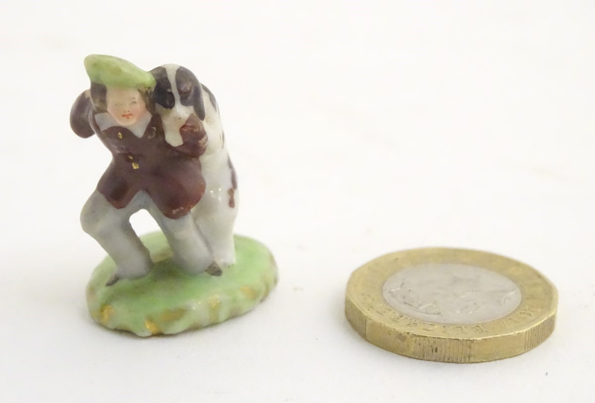 A miniature Rockingham style figure of a man wearing a tam-o-shanter with a dog on an oval base. - Image 7 of 7