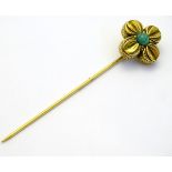 A yellow metal stick pin set with green stone CONDITION: Please Note - we do not