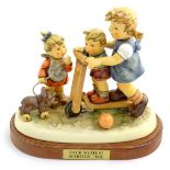 A large Hummel Goebel figural group, Scooter Time! (model no. 2070), on a titled wooden base.