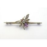 A white metal bar brooch set with insect / butterfly with purple white and red stones.