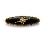 Mourning / Memorial jewellery: A 19thC gold brooch set with black enamel and seed pearl decoration