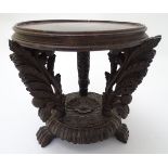 A 19thC carved wooden jardiniere stand of squat form with acanthus leaf and floral decoration,