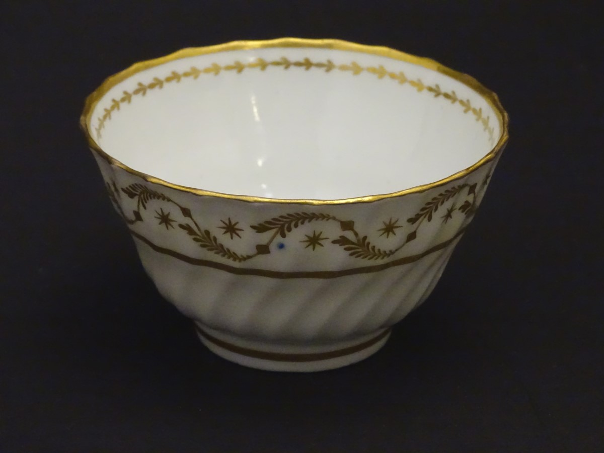 A 19thC white porcelain tea bowl with ribbed sides and gilt decoration of stylised foliage and - Image 7 of 7
