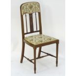 An early 20thC mahogany bedroom chair with a slatted backrest and inlaid decoration,