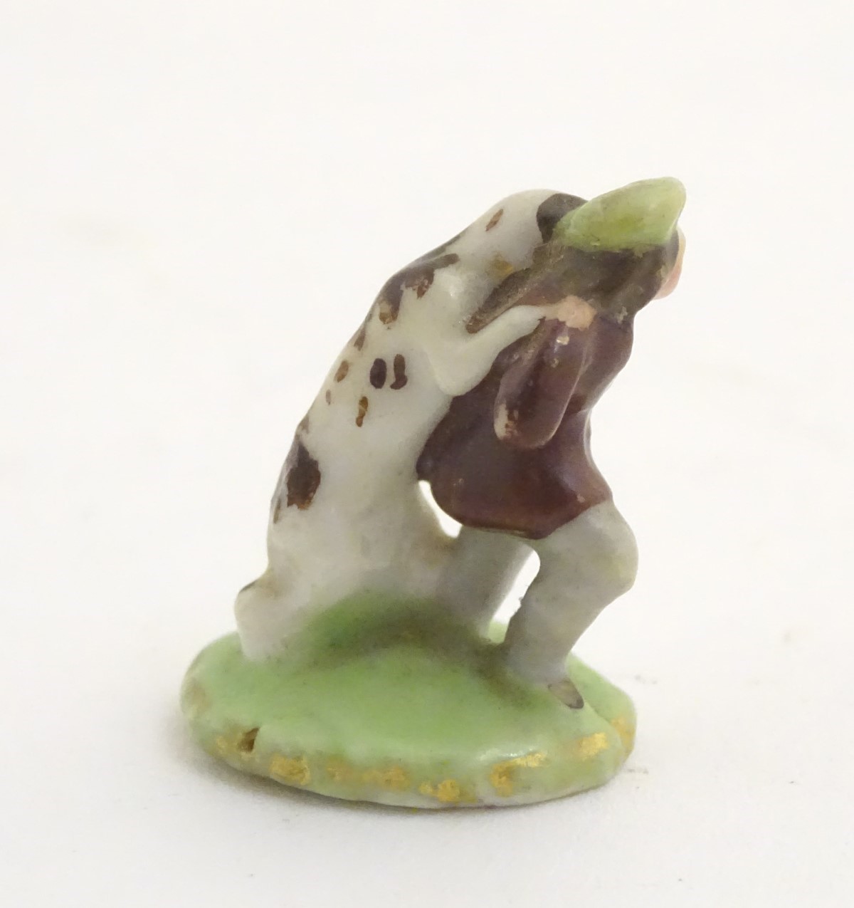 A miniature Rockingham style figure of a man wearing a tam-o-shanter with a dog on an oval base. - Image 6 of 7