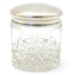 A cut glass dressing table jar with silver top hallmarked Birmingham 1924 maker Sanders & Mackenzie.