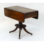 A mid 19thC mahogany sofa table with a single short drawer and opposing sham drawer,