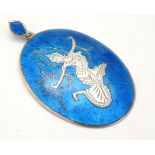 A silver pendant with turquoise guilloche enamel decoration with deity detail.