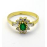 An 18ct gold ring set with emerald and white stones CONDITION: Please Note - we do