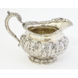 A 19thC Irish silver jug with acanthus and floral decoration hallmarked Dublin 1828 4 3/4" high