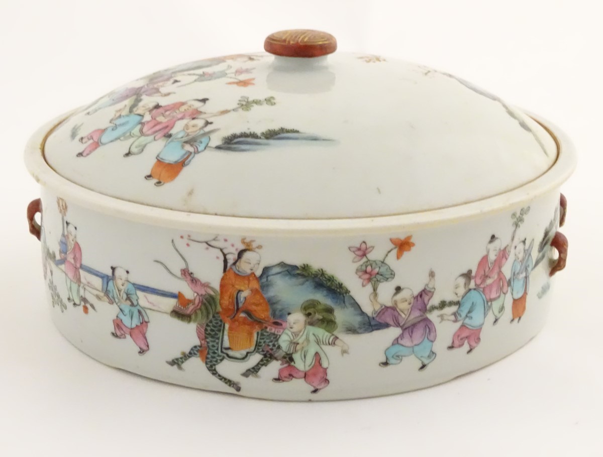 A Chinese lidded pot decorated with figures in a garden with flowers, fruit, vases etc. - Image 5 of 8