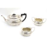 A 3-piece silver plate tea set comprising teapot, milk jug and sugar.