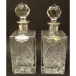 A pair of lead crystal decanters of squared form with mounted with silver collars,