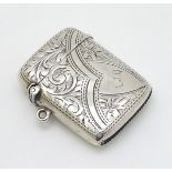 A silver vesta case with engraved decoration. Hallmarked Birmingham 1904 maker Thomas Bishton.