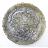 An Oriental jade plate with carved relief depicting 3 fish / carp.