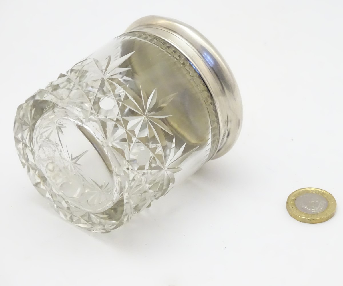 A cut glass dressing table jar with silver top hallmarked Birmingham 1924 maker Sanders & Mackenzie. - Image 4 of 6