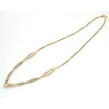 A 9ct gold necklace with yellow, rose and white gold detail.