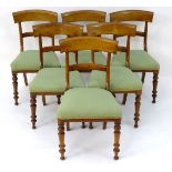 A set of six Victorian mahogany dining chairs with curved top rails above upholstered seats and