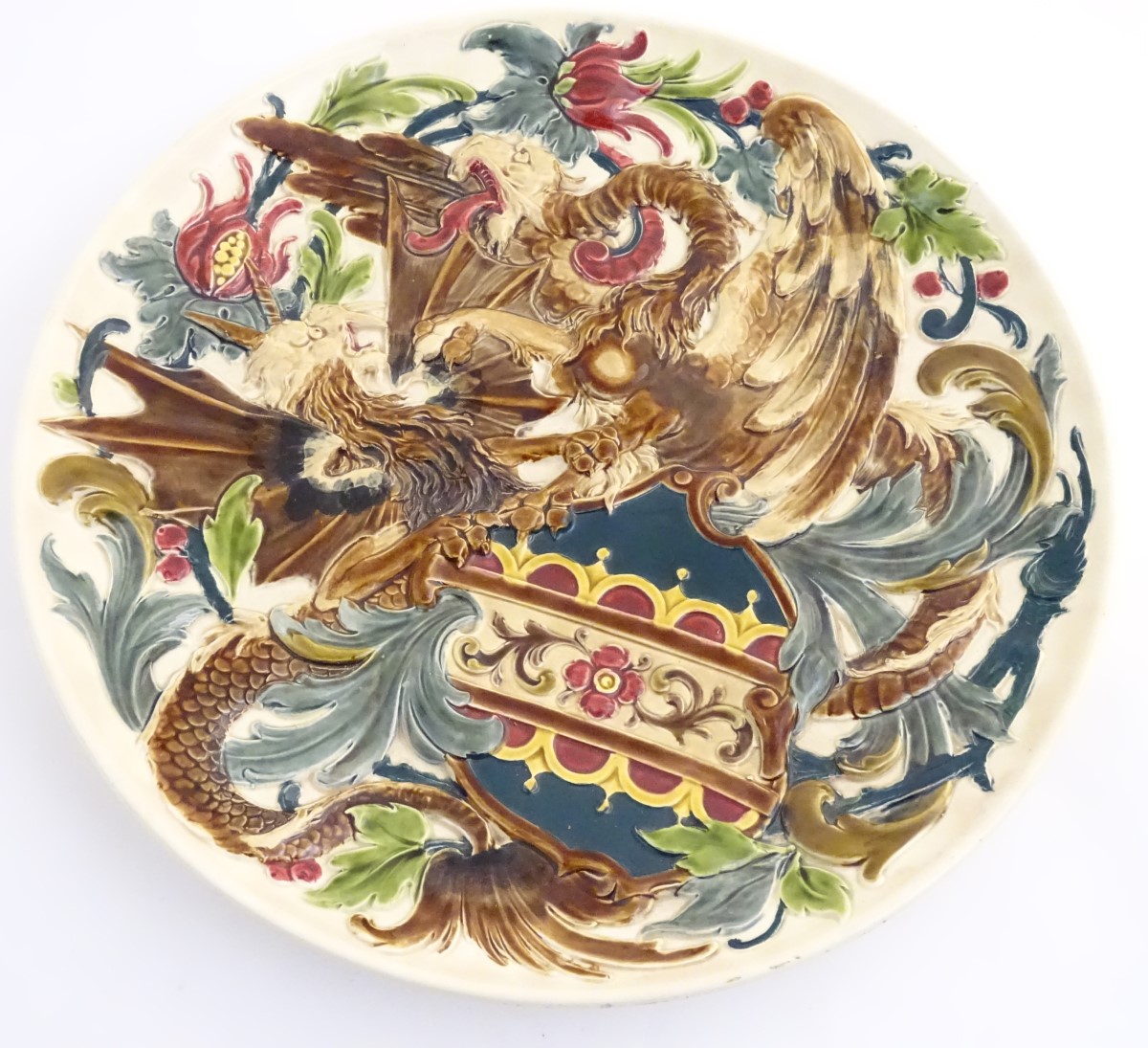 A large 19thC Austrian charger decorated in relief with two fighting griffins / dragons with a - Image 4 of 8