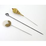 Three decorative hat pins,