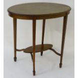An early 20thC mahogany oval occasional table with a cross banded top,