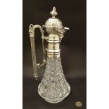 A late 19th / early 20thC cut glass claret jug with ornate silver plate mounts,