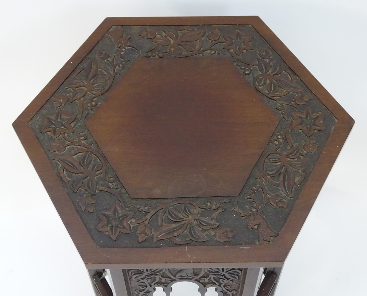 A walnut Liberty style table with a hexagonal carved top above six matching carved facades with - Image 6 of 13